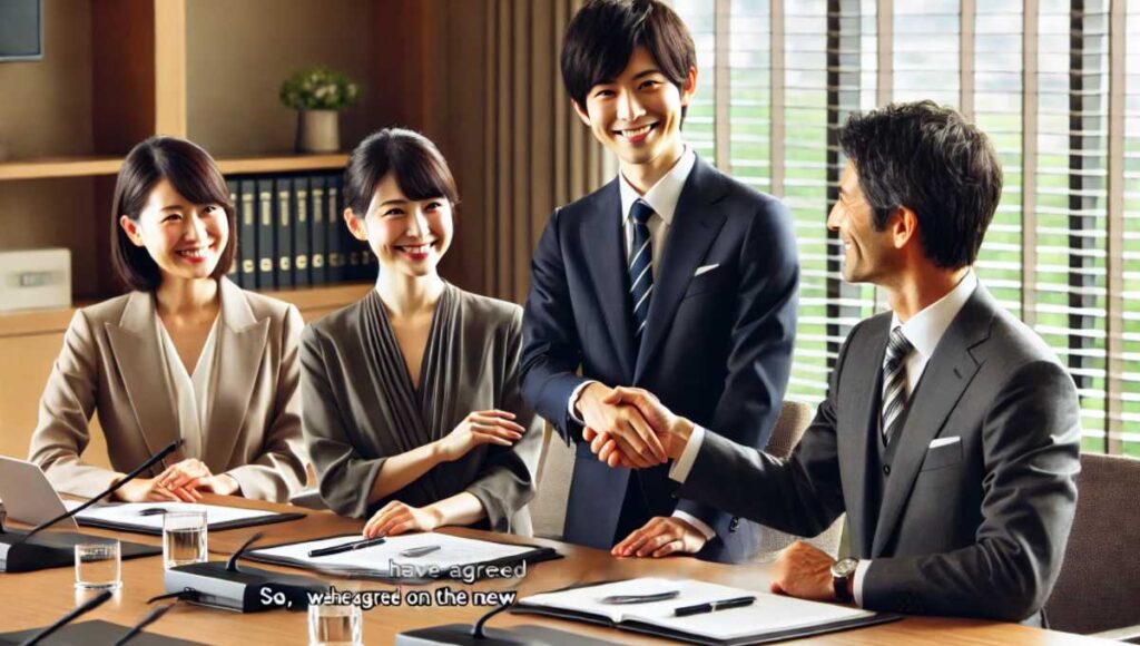 会議室で日本人ビジネスマンたちが微笑みながら握手をして合意を示している様子。テキストオーバーレイ：「So, we have agreed on the new delivery schedule.」